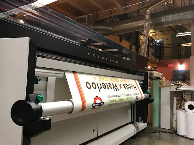 A color print coming out of a large format printer
