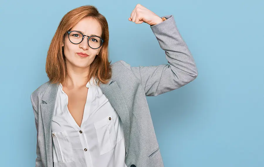 A businesswoman flexing her muscles