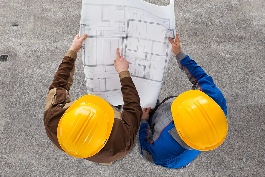 Construction workers looking at construction plans